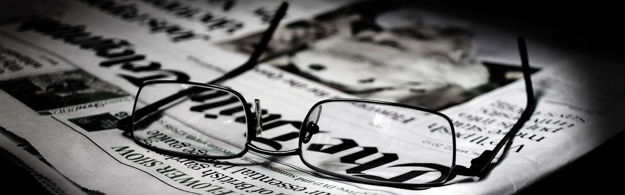 Glasses laid on newspaper