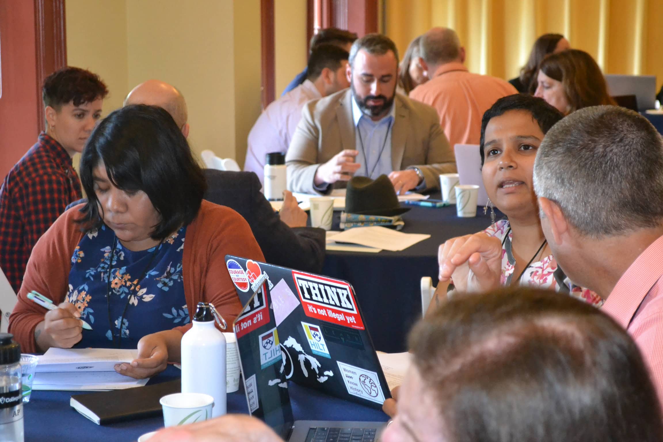 A group of people discussing at a conference.