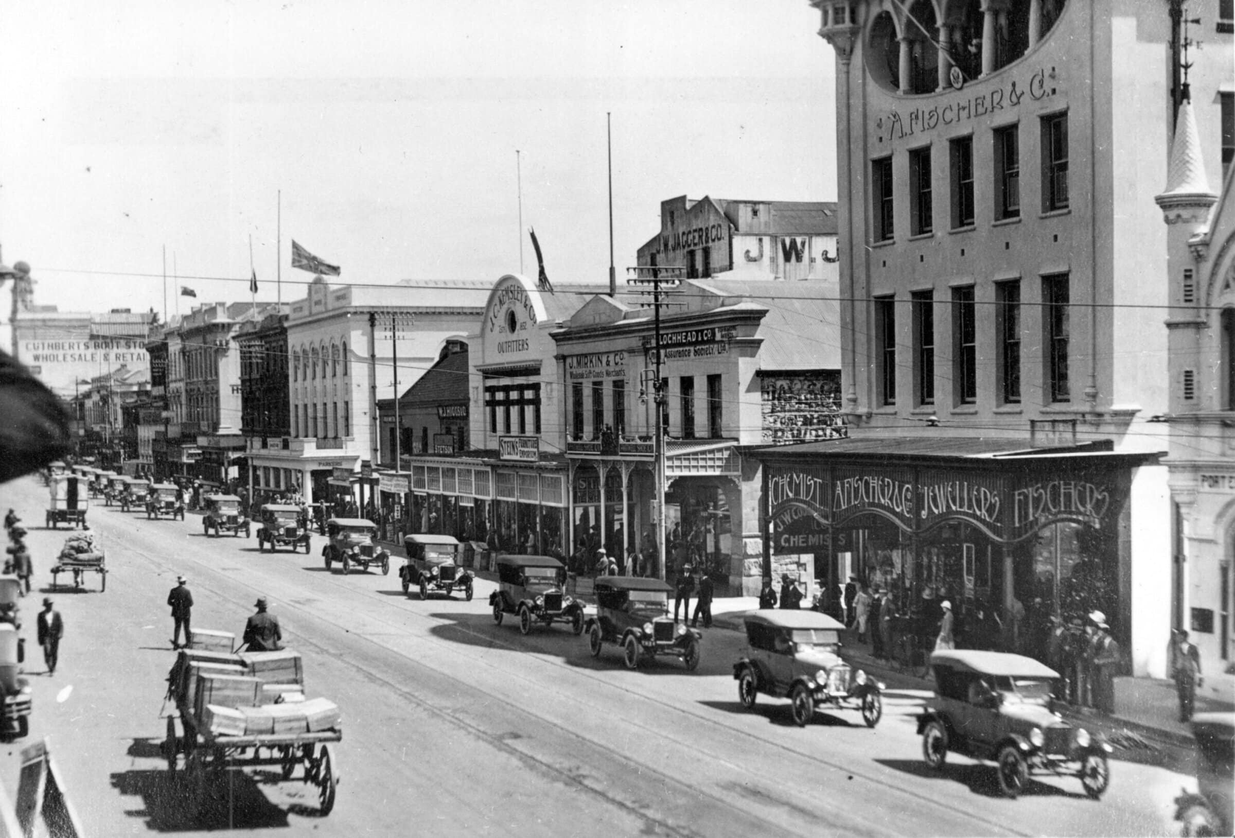 A wide lens shot of a street in Port Elizabeth with a convoy of Ford Model T cars approaching