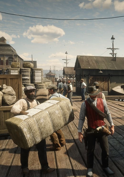 A screen shot from the video gam Red Dead Redemption II. A cowboy in a red vest walks on a pier with people moving around behind him.