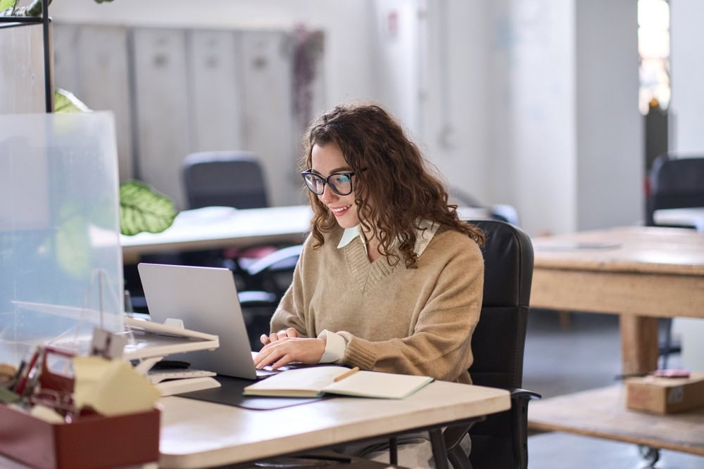 Woman working at desk in well-lit office
